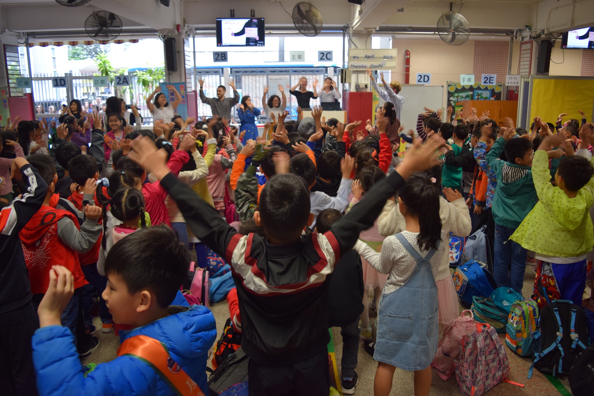 Students enjoy the morning assembly held by the 9 NETs on English Day.